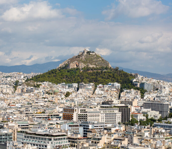An aerial view of buildings and hills in Athens, Greece